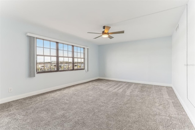 unfurnished room featuring ceiling fan and carpet flooring