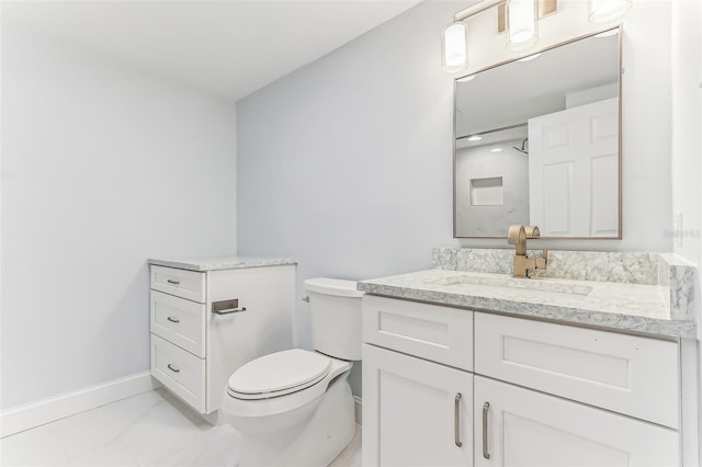 bathroom featuring toilet and vanity