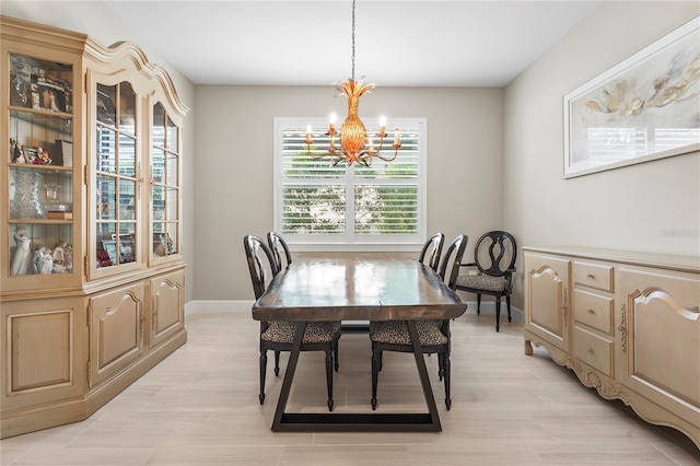 dining room featuring a notable chandelier and light hardwood / wood-style flooring