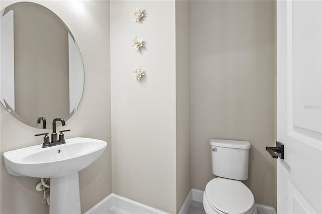 bathroom featuring sink and toilet