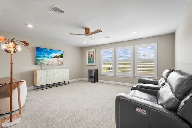 carpeted living room with ceiling fan