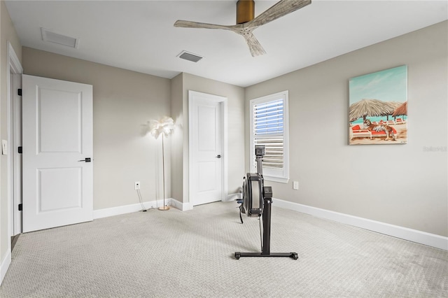 workout room featuring light colored carpet and ceiling fan