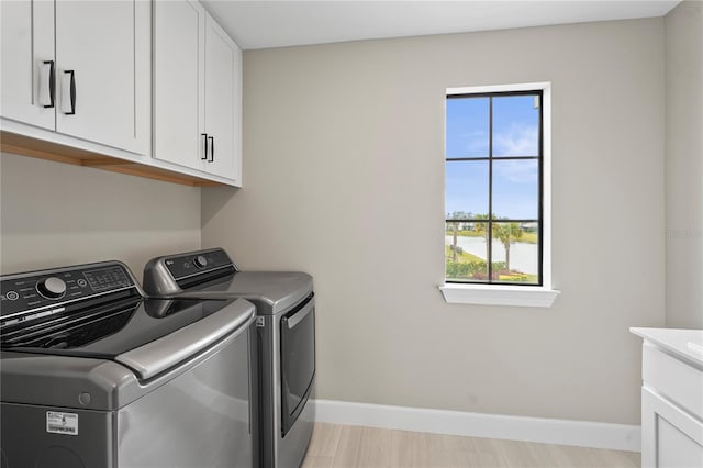 laundry room with cabinets and washing machine and dryer