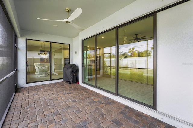 unfurnished sunroom featuring ceiling fan