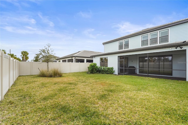 rear view of house featuring a lawn