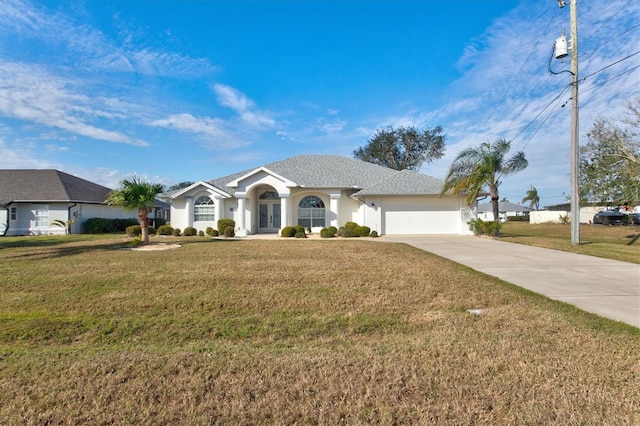 single story home featuring a garage and a front yard