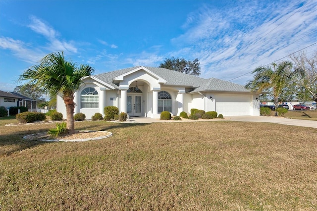 view of front of home featuring a garage and a front lawn