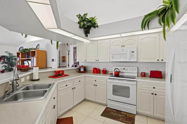 kitchen with sink, light tile patterned floors, white appliances, decorative backsplash, and white cabinets