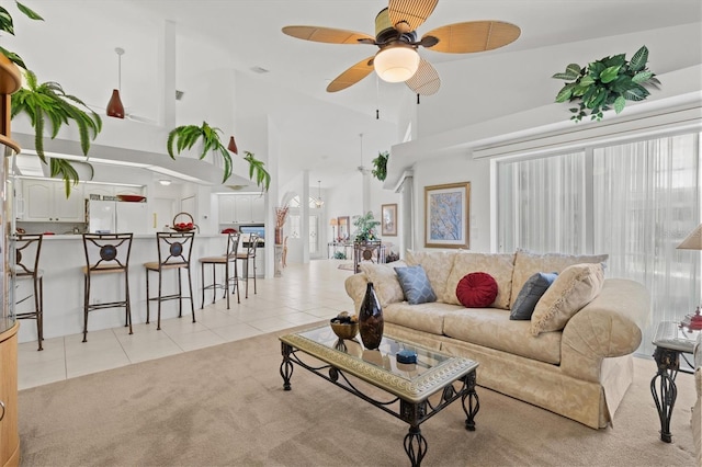 tiled living room featuring high vaulted ceiling and ceiling fan