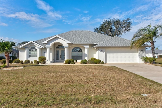 ranch-style house with a garage, french doors, and a front lawn