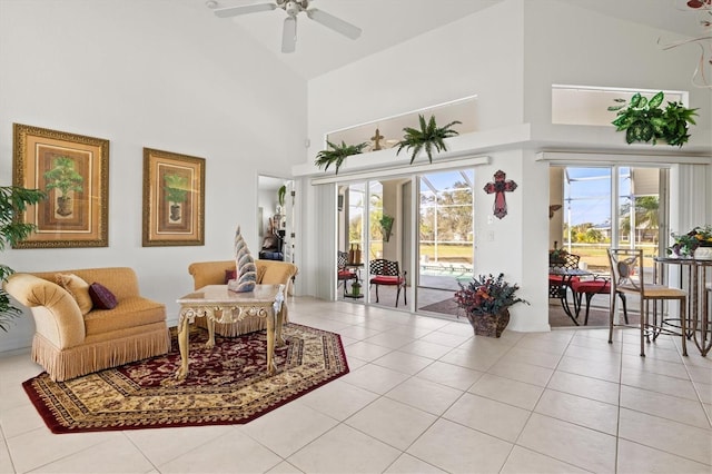 interior space with light tile patterned flooring, ceiling fan, and high vaulted ceiling