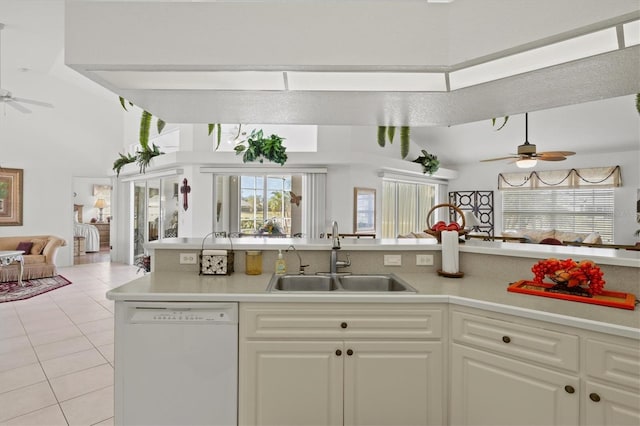 kitchen with ceiling fan, white dishwasher, sink, and light tile patterned floors