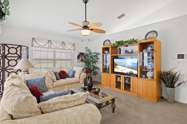 carpeted living room with vaulted ceiling and ceiling fan