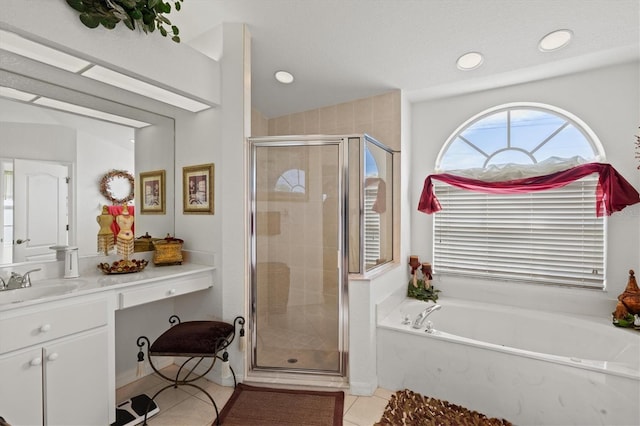 bathroom featuring shower with separate bathtub, tile patterned floors, and vanity