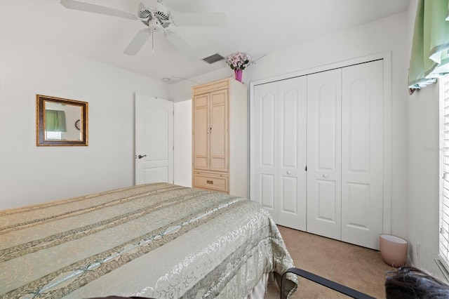 bedroom with a closet, ceiling fan, and carpet flooring