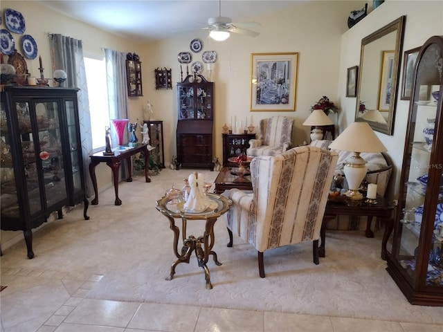 living area featuring ceiling fan and light tile patterned flooring