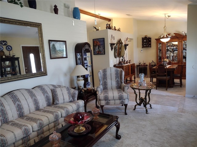 living room with beam ceiling and a towering ceiling