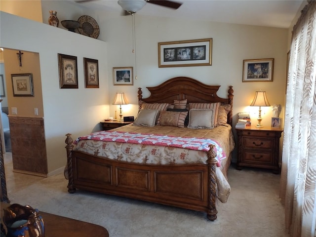 carpeted bedroom with vaulted ceiling and ceiling fan