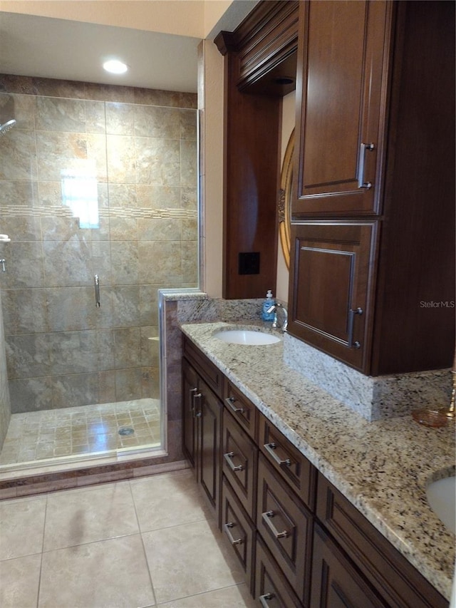 bathroom featuring tile patterned floors, vanity, and a shower with shower door