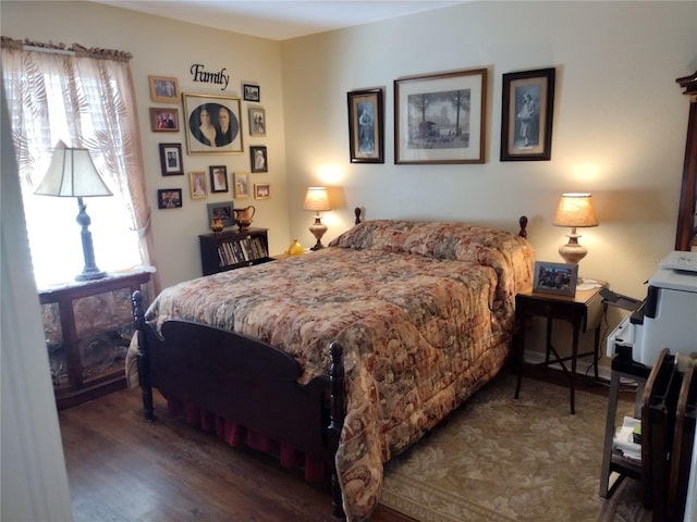 bedroom with dark hardwood / wood-style flooring