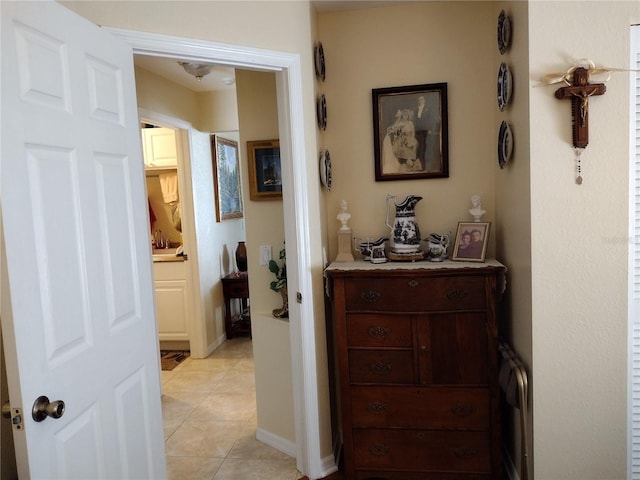 hall with light tile patterned floors