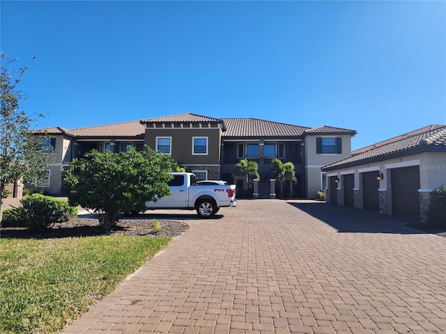 mediterranean / spanish-style home with a garage