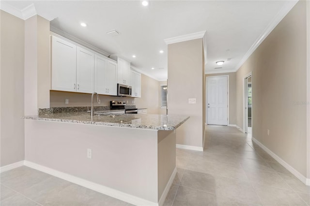 kitchen featuring white cabinetry, appliances with stainless steel finishes, kitchen peninsula, and light stone counters