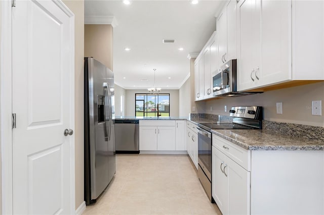 kitchen featuring light stone countertops, appliances with stainless steel finishes, white cabinetry, kitchen peninsula, and light tile patterned floors