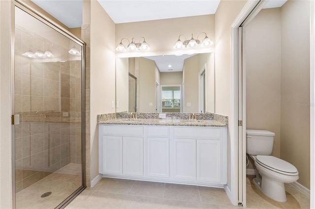 bathroom featuring toilet, vanity, tile patterned flooring, and an enclosed shower