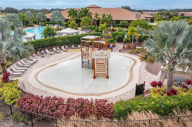 view of swimming pool featuring a playground