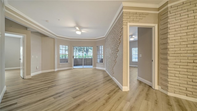 interior space with light hardwood / wood-style flooring, brick wall, and ornamental molding