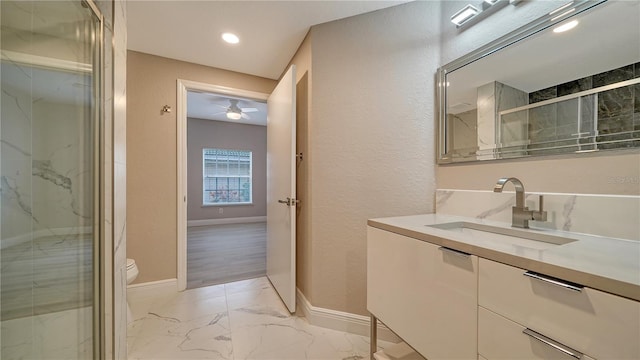 bathroom featuring a shower with shower door, toilet, and vanity