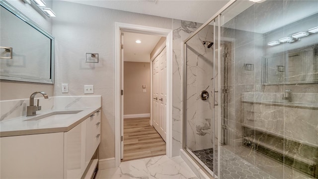 bathroom featuring an enclosed shower and vanity