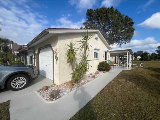 view of home's exterior with a garage and a yard