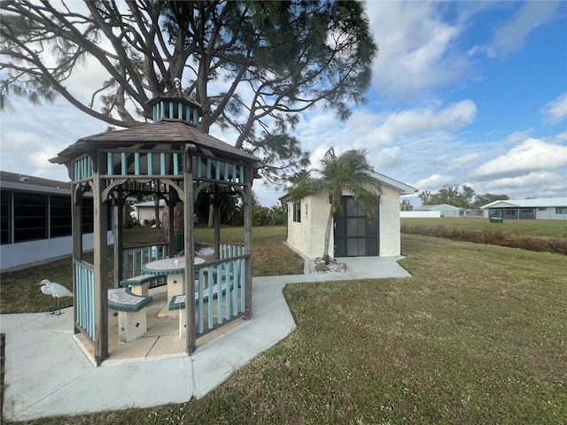 exterior space with a gazebo and a storage shed