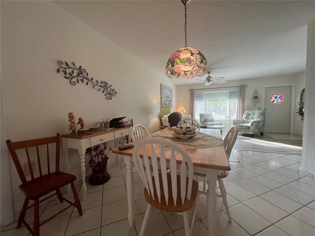 tiled dining space with ceiling fan