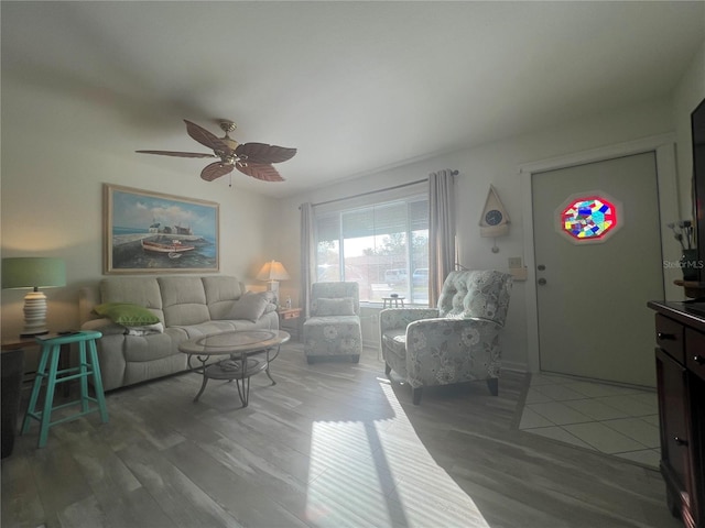 living room featuring ceiling fan and wood-type flooring