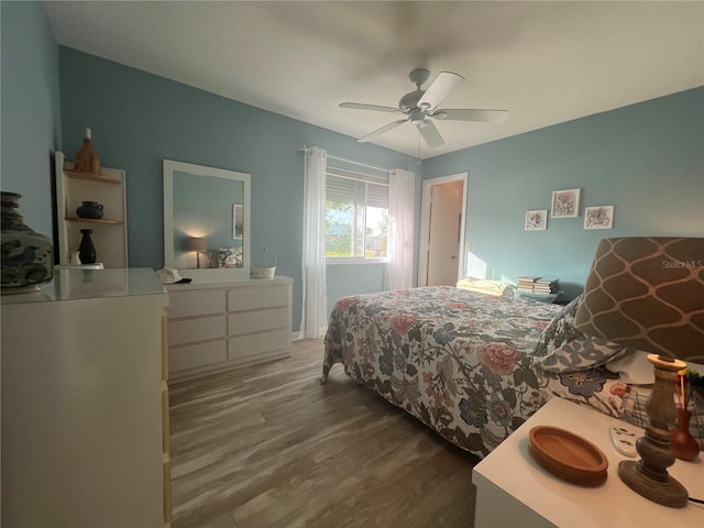 bedroom featuring ceiling fan and dark wood-type flooring