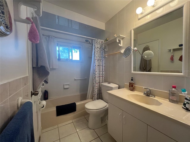 full bathroom with shower / bath combination with curtain, tile patterned floors, vanity, tile walls, and toilet