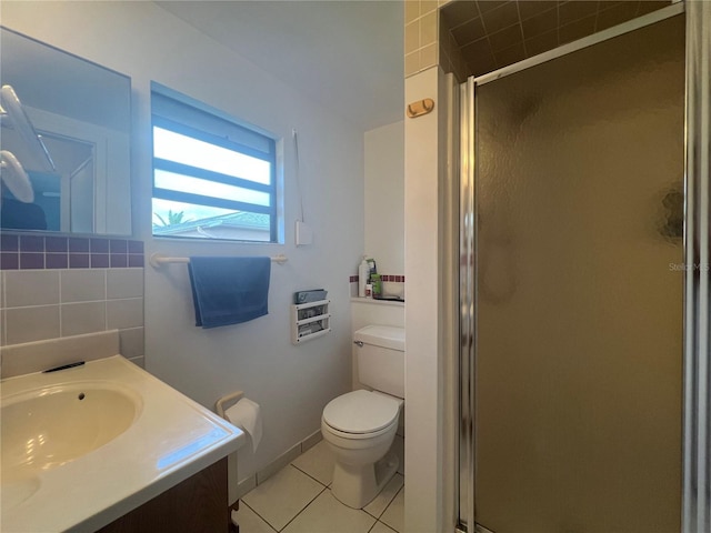 bathroom with tile patterned flooring, vanity, toilet, and a shower with shower door