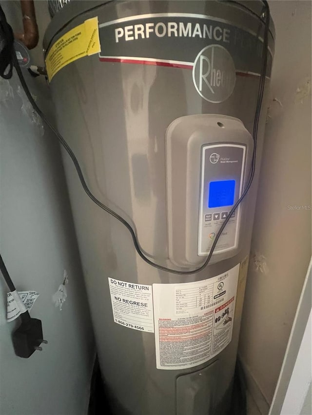 utility room featuring electric water heater