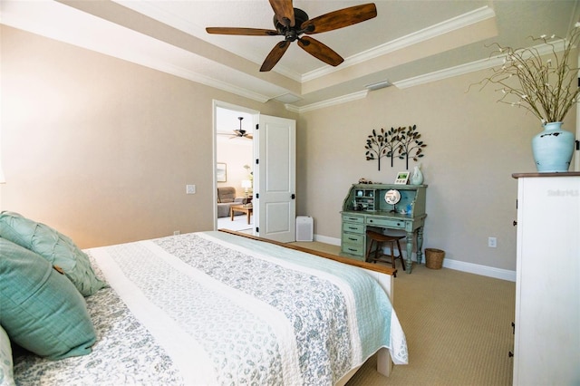 bedroom with ceiling fan, carpet floors, crown molding, and a tray ceiling