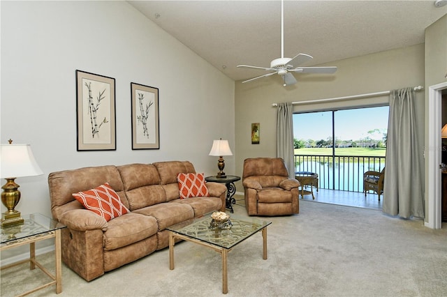 living room featuring carpet flooring, ceiling fan, a water view, and high vaulted ceiling