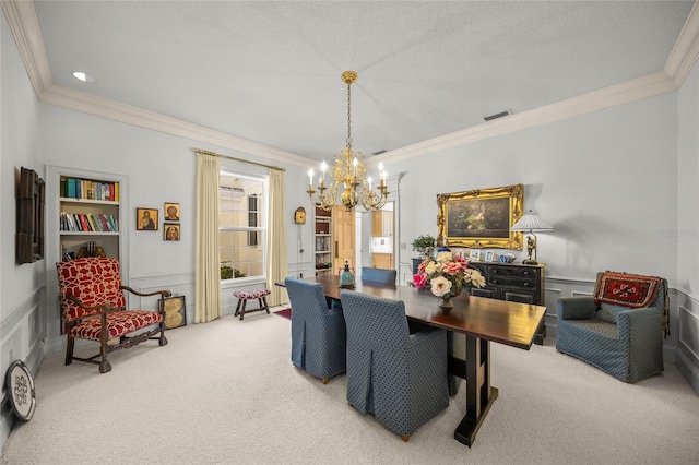 dining area with built in shelves, a chandelier, crown molding, and carpet flooring