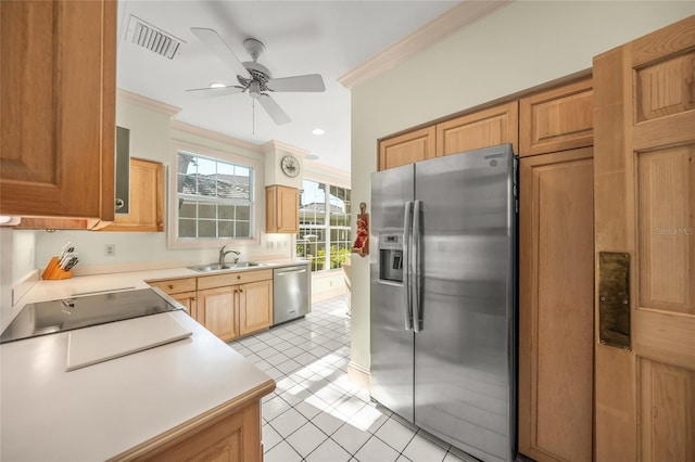 kitchen featuring stainless steel appliances, sink, ceiling fan, light tile patterned floors, and ornamental molding