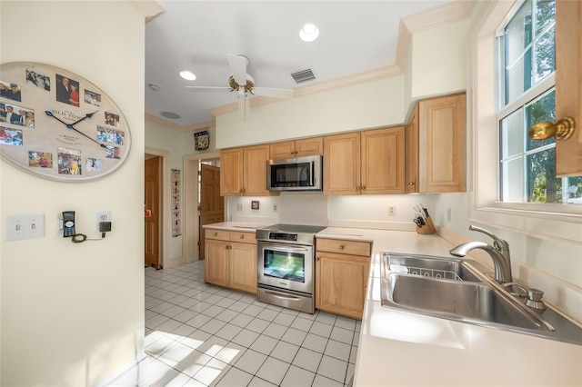 kitchen with stainless steel appliances, ornamental molding, ceiling fan, sink, and light tile patterned flooring