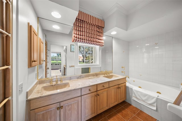 bathroom featuring vanity, tiled tub, crown molding, and tile patterned floors