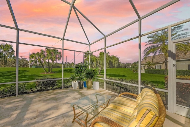 patio terrace at dusk with a lanai and a lawn