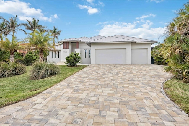 view of front of house with a garage and a front lawn