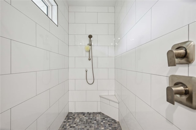 bathroom with a tile shower